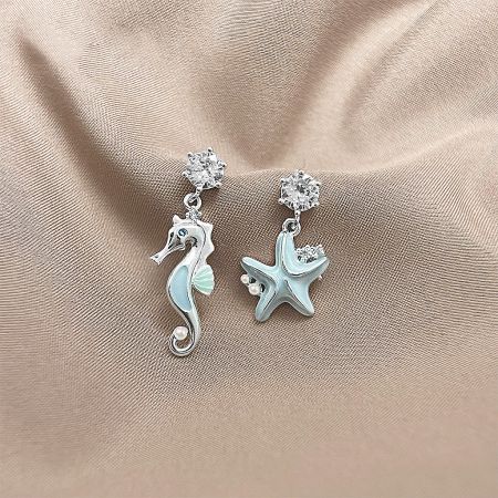 Front view of the light blue enamel seahorse and starfish earrings, displaying their unique asymmetrical design.