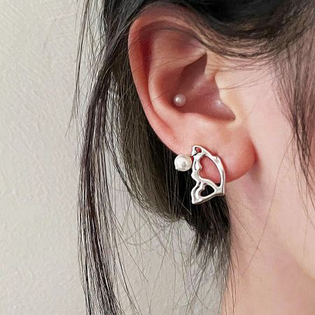 Model wearing an abstract liquid-metal style silver earring from the 5-pair set.