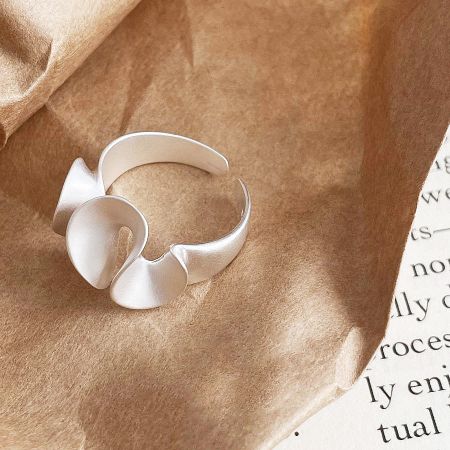 Detailed view of a sterling silver ring with an abstract, wrinkled matte finish.