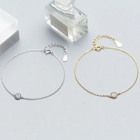 Elegant product shot of the silver and gold evil eye bracelets.