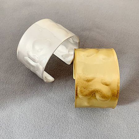 Egypt-style hammered wide arm cuff bracelets in both silver and gold finishes.