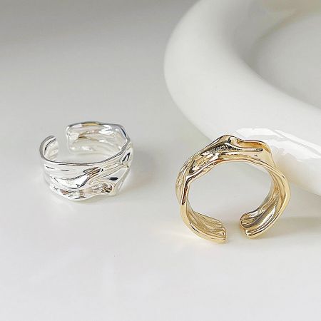 Top-down view of the gold and silver irregular pleats open rings.