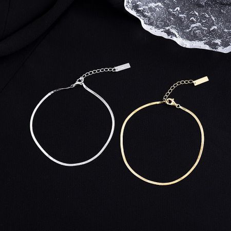 Detailed view of the sleek snake chain design of the sterling silver anklet.