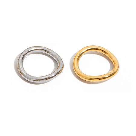 Close-up of the organic wavy design of the gold and silver two-tone stainless steel rings.