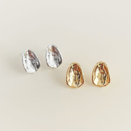 Two pairs of oval button stud earrings, one in silver and one in gold, shown side-by-side.