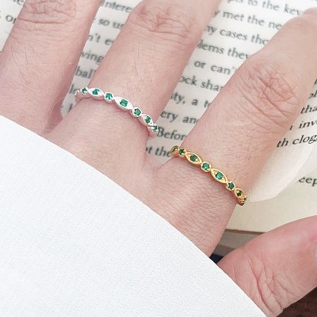 Wholesale 925 Sterling Silver Green Zircon Stone Open Stacking Rings (Set of 5) - A model wearing the wholesale 925 sterling silver open stacking rings with green zircon stones, showcasing both the silver and gold finish options.