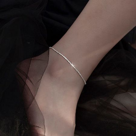 Elegant 925 sterling silver anklet showcased on a woman's ankle.