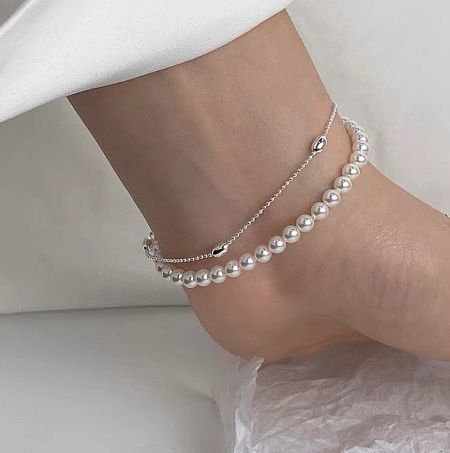 A detailed view of the sterling silver pearl bracelet, showing the quality of the chain and pearl fitting.