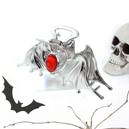 Detailed view of the silver bat hair clip with a red gemstone.