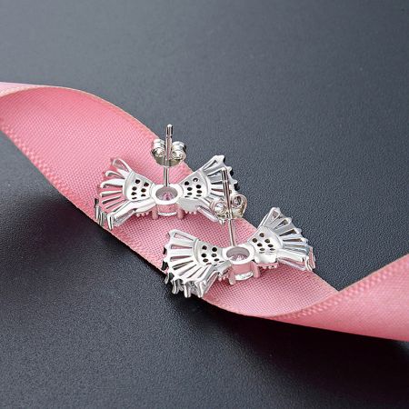 Back view of the sterling silver bow stud earrings, showing the post and backing.