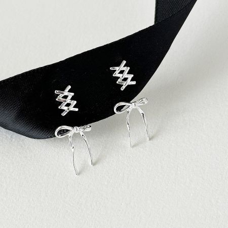 Detailed product shot of the 925 sterling silver bowknot stud earrings.