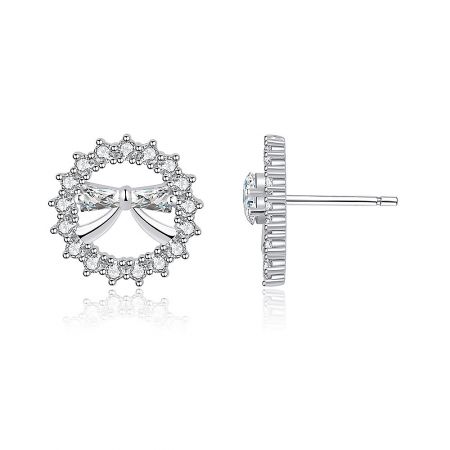 Side view of the silver bow stud earring showcasing the post-back closure and the intricate setting of the small stones.