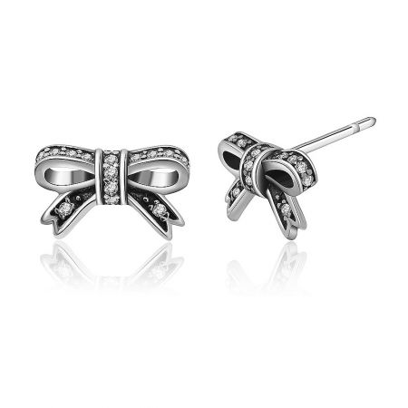 Detailed view of the silver bow earrings showcasing the post closure and gemstone setting.