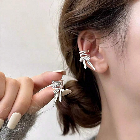 Model showcasing the delicate design of the silver bowknot earrings.