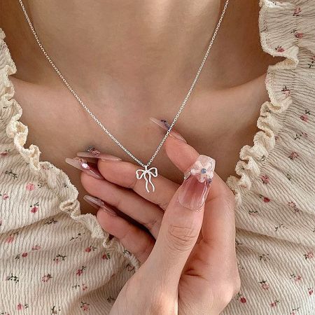 925 Sterling Silver Asymmetrical Bow Ribbon Pendant Necklace Set of 5 - Close-up of a 925 sterling silver asymmetrical bow ribbon pendant on a delicate chain, showcasing its elegant and whimsical design.