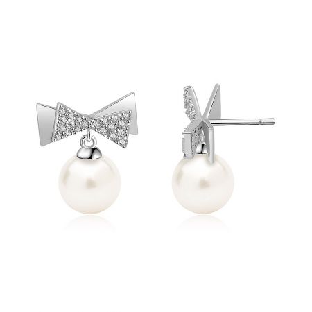 Side view of the Bow Pearl Drop Earrings showing the silver bow top with clear gemstones and the post backing.