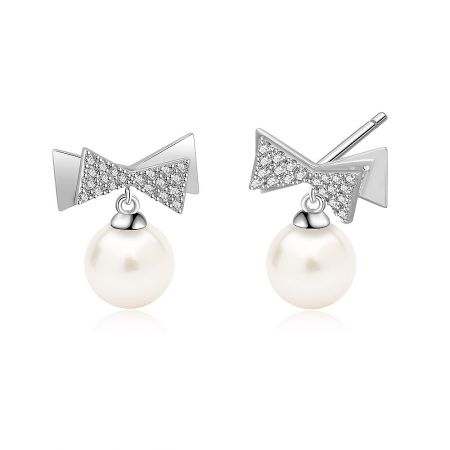 Detailed shot of the Bow 7mm Pearl Drop Earrings, highlighting the brilliant cubic zirconia and the smooth surface of the pearl.