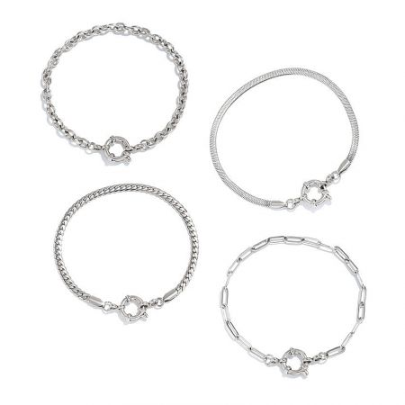 Set of stylish silver-plated stainless steel chain bracelets displayed on a white surface.
