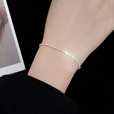 Another view of the gypsophila bracelet on a wrist.