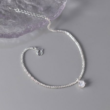 A luxurious 925 silver bracelet showcasing a sparkling clear zircon stone, demonstrating the set's versatile elegance.