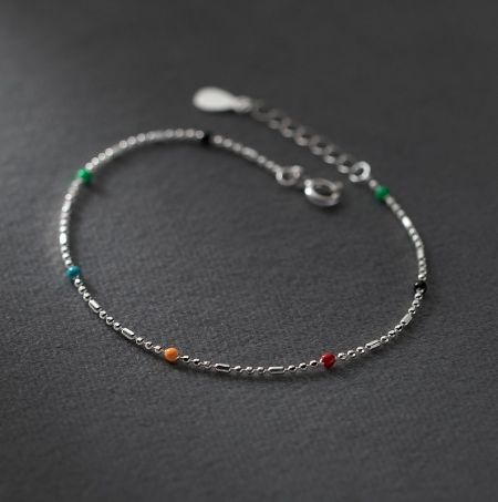 Close-up detail of the colorful beads and fine craftsmanship of the sterling silver bracelet.