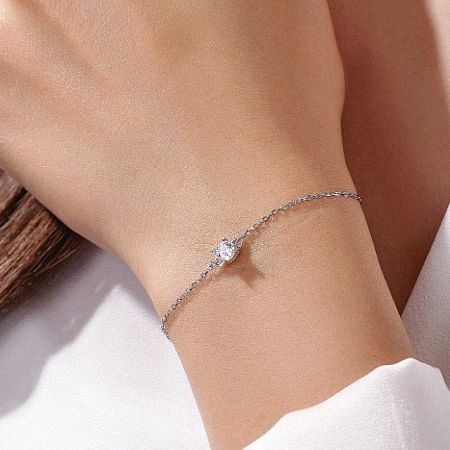 Close-up of the silver single cubic zirconia thin chain bracelet on a white background.