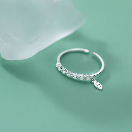 The adjustable sterling silver ring worn on a finger to demonstrate its elegant fit and style.