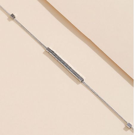 Detailed view of a sterling silver bracelet with a unique grid-patterned central element.