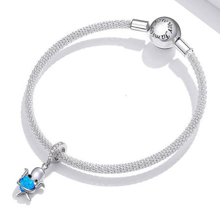 A silver woven-style bracelet adorned with the blue opal octopus charm, showing the 'forever grateful' engraved clasp.