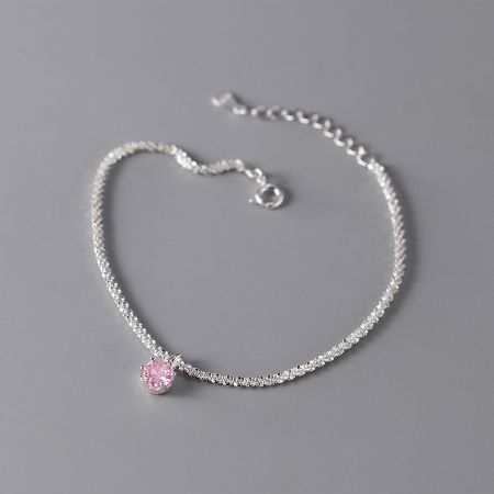 Close-up shot of the delicate 925 silver bracelet featuring a soft pink zircon, perfect for summer fashion.