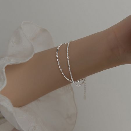 Model wearing the layered 925 sterling silver crystal bead chain bracelets to showcase the fit and style.