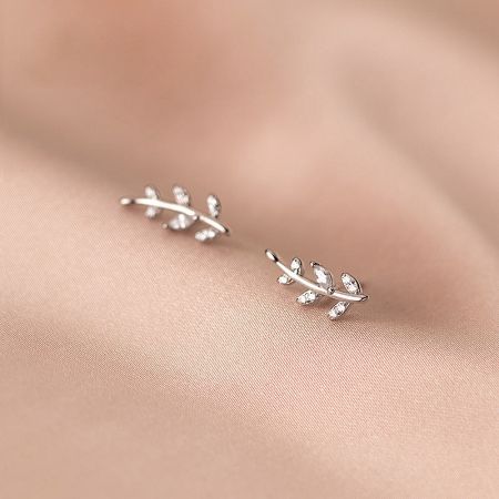 Detailed view of the sterling silver olive leaf stud earrings showcasing the intricate branch design and CZ stones.