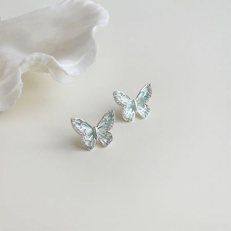 Detailed close-up of the silver-plated butterfly earrings showing the intricate enamel work.