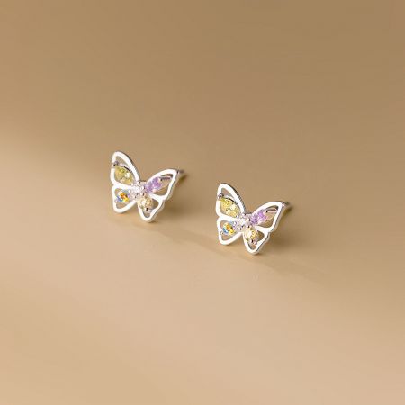 Close-up view of a single silver butterfly earring showcasing the detailed gemstone setting.