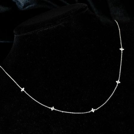 Close-up of a silver butterfly charm necklace with cubic zirconia from the five-piece set.