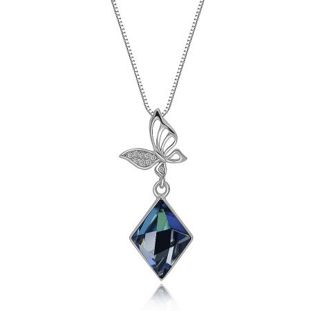 Close-up view of the butterfly pendant with intricate pavé details and a central blue Swarovski crystal.