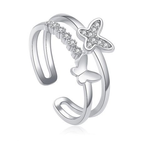 A detailed view of the double butterfly ring, showing the polished rhodium finish and the sparkle of the set stones.