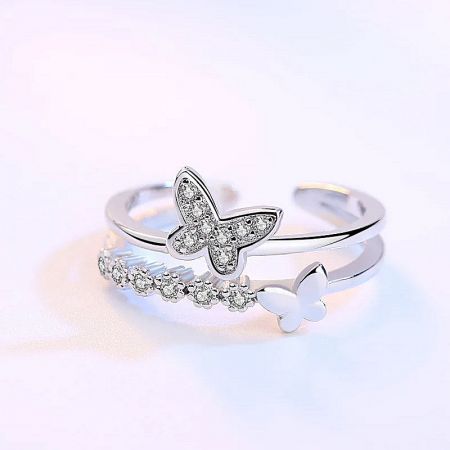 Two different butterfly motif rings from the sterling silver collection displayed together.