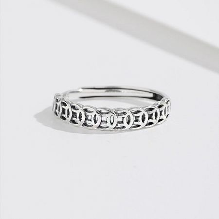 Detailed view of a silver ring from the adjustable set, featuring a Celtic knot design.