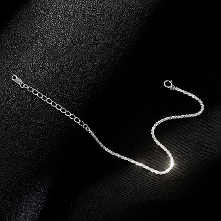 The 925 sterling silver chain bracelet displayed on a dark background.