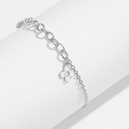 An elegant silver chain bracelet with a delicate flower charm.