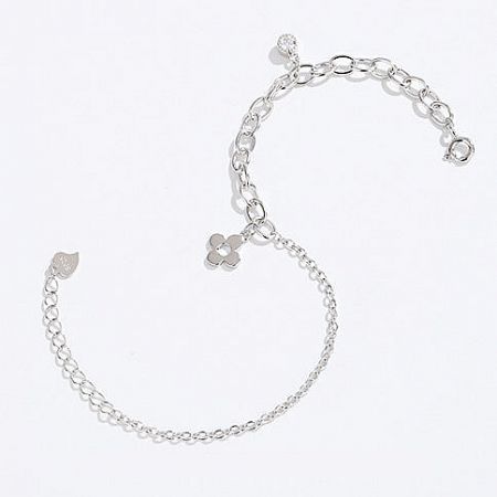 A unique silver chain bracelet with a leaf-shaped clasp and a flower charm.