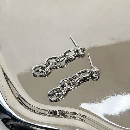A detailed view of the silver-plated chain earrings highlighting the brilliant zircon gemstones.