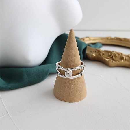 Product shot of a sterling silver chain ring against a clean background, highlighting its craftsmanship.