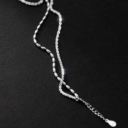 Product shot of a two-strand sterling silver chain bracelet from the set, highlighting its polished finish.