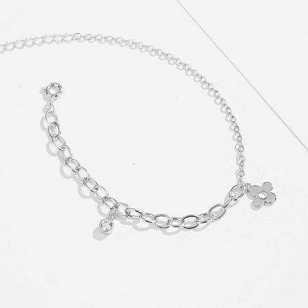 A silver jewelry piece with decorative charms on a white background.