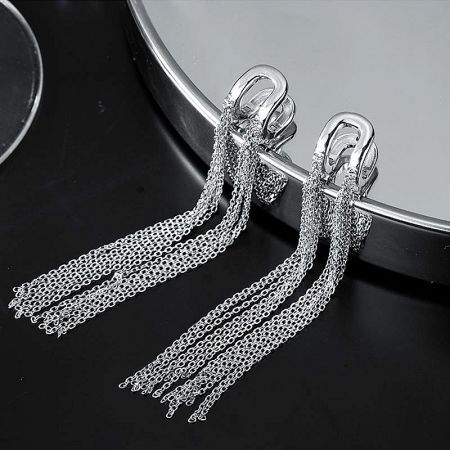 A pair of sterling silver chain tassel earrings displayed on a white surface.