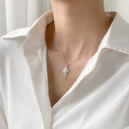 A model wearing the 925 Sterling Silver Seashell Pendant Necklace, demonstrating its length and style.