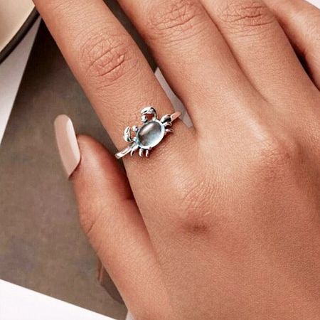 The sterling silver crab ring featuring a sophisticated gray stone.