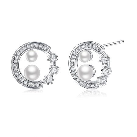Side angle of the silver crescent moon pearl earrings, highlighting the elegant craftsmanship and post closure.